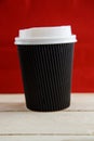 Cardboard disposable cups isolated on a wooden background. Front view Royalty Free Stock Photo