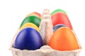 Cardboard egg box with Easter colored eggs Royalty Free Stock Photo