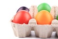 Cardboard egg box with Easter colored eggs Royalty Free Stock Photo