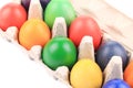 Cardboard egg box with Easter colored eggs. Royalty Free Stock Photo