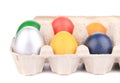 Cardboard egg box with Easter colored eggs Royalty Free Stock Photo