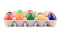 Cardboard egg box with Easter colored eggs. Royalty Free Stock Photo