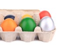 Cardboard egg box with Easter colored eggs. Royalty Free Stock Photo
