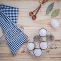 Cardboard egg box with eggs ,pepper bottle ,wooden spoons ,bay l