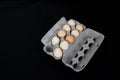 Cardboard egg box with nine eggs on black mat background Royalty Free Stock Photo