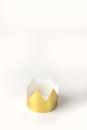 Cardboard golden crowns lying on a white table. Minimalistic style. Place for text. Copyspace.
