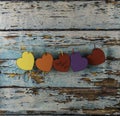 Cardboard hearts hung with tweezers to congratulate Mother`s Day  Multi-colored hearts on weathered blue wooden background vintag Royalty Free Stock Photo