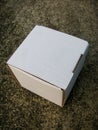 Cardboard mailing box on concrete floor