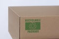 Cardboard pakage with recycling symbol.