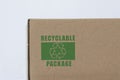 Cardboard pakage with recycling symbol.