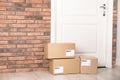 Cardboard parcel boxes on floor near apartment entrance