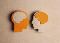 Cardboard profiles with brain symbol on a brown background.. World Multiple Sclerosis Day