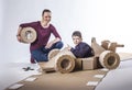 Cardboard racing car and happy family Royalty Free Stock Photo