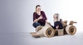Cardboard racing car and happy family. thumbs up. Royalty Free Stock Photo