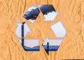 Cardboard with the recycling symbol showing a chimney from a polluting industry below