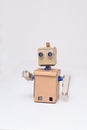 Cardboard robot on white background at home
