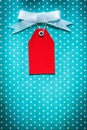 Cardboard sale tag on blue polka-dot table cloth