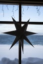 The cardboard seven-pointed star hang on the wooden