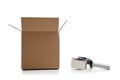 Cardboard shipping box with a tape gun Royalty Free Stock Photo