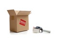 Cardboard shipping box with a tape gun Royalty Free Stock Photo