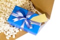 Cardboard shipping delivery box blue gift inside, polystyrene packing pieces, top view Royalty Free Stock Photo