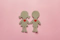 Cardboard silhouettes girl and boy with hearts on a , pink. Vale