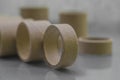 Cardboard spools for winding. Reels made of cardboard. Background of cardboard bobbins. Selective focus