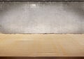 Cardboard table with concrete wall background