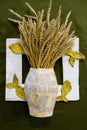 Cardboard vase from newspapers, in vase of wheat. A photo frame with fish. Royalty Free Stock Photo