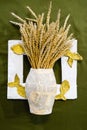 Cardboard vase from newspapers, in vase of wheat. A photo frame with fish. Royalty Free Stock Photo