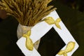 Cardboard vase from newspapers, in vase of wheat. A photo frame with fish. Royalty Free Stock Photo