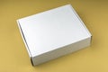 Cardboard white box on beige background. Packing box in stock