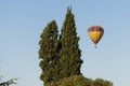 A hot air balloon sails a blue sky.