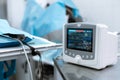 Cardiac monitor at operating table with dog on background. Pet surgery Royalty Free Stock Photo