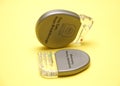 Implantable cardiac defibrillator devices isolated on yellow background. Royalty Free Stock Photo