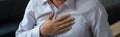 Cardiac warning Asian mans painful expression signals heart attack symptoms