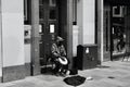 Black and white image of a street musician in Queen Street Cardiff