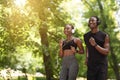 Cardio Training. Positive African American Couple Jogging Together In City Park Royalty Free Stock Photo