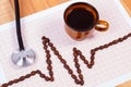 Cardiogram line of coffee grains, cup of coffee and stethoscope, medicine and healthcare concept Royalty Free Stock Photo