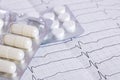 Cardiogram results on paper and pills, heart health