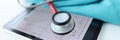 Cardiogram results and stethoscope on tablet closeup