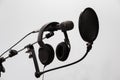 Cardioid condenser microphone, headphones and pop filter on a gray background. Home recording Studio Royalty Free Stock Photo