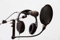 Cardioid condenser microphone, headphones and pop filter on a gray background. Home recording Studio Royalty Free Stock Photo