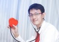 Cardiologist checking red heart with stethoscope. cardiology con