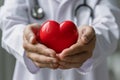 Cardiologist doctor holding a red heart in his hands , cardiac disease or heart failure concept Royalty Free Stock Photo