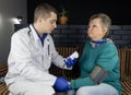 Cardiologist doctor measures blood pressure of a senior woman. Device for self-diagnosis and control of the heart. High or low Royalty Free Stock Photo