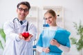 The cardiologist with his nurse assistant posing in hospital