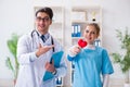 The cardiologist with his nurse assistant posing in hospital