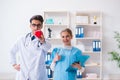 The cardiologist with his nurse assistant posing in hospital