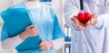 Cardiologist with his nurse assistant posing in hospital